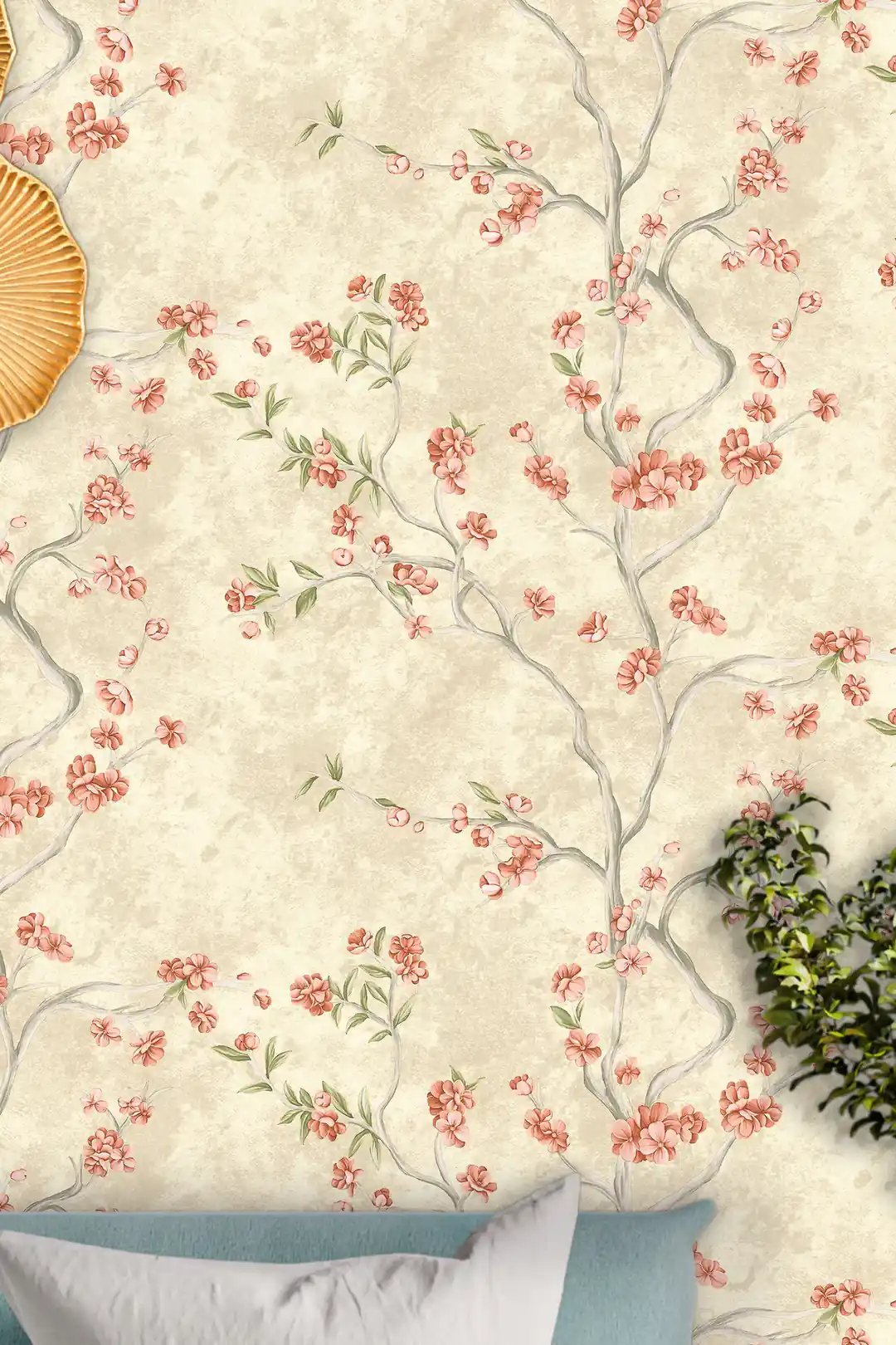 Close-up of pink cherry blossom branches scattered across an ivory wallpaper with a golden decorative piece on the wall