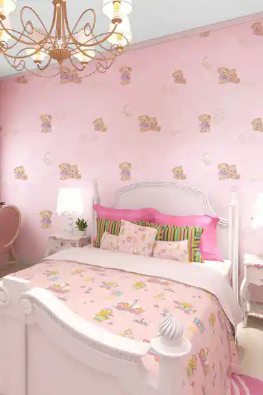 Pink nursery bedroom with teddy bear wallpaper installed behind a white bed and golden chandelier