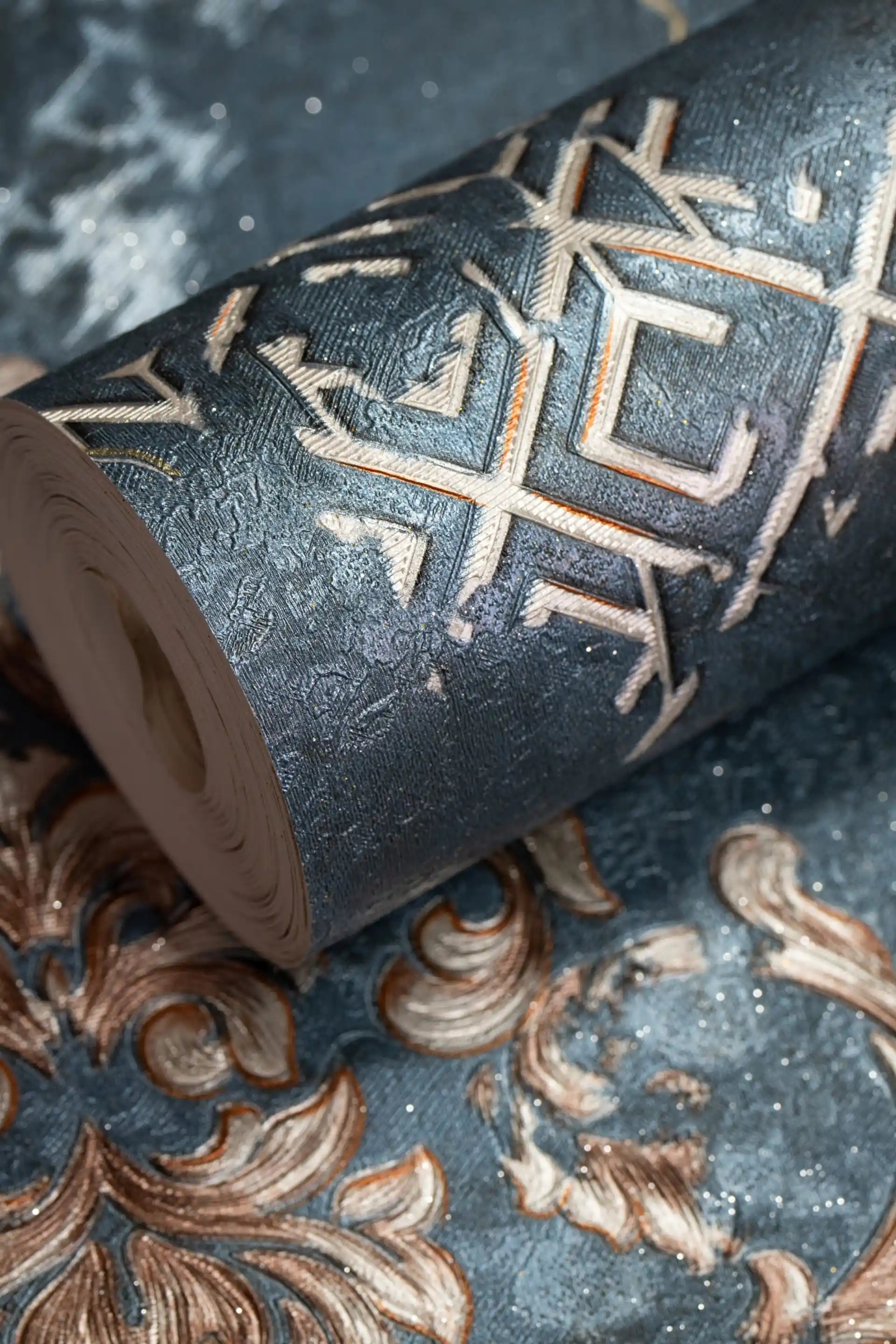 Wallpaper roll with ornate baroque scrollwork and bronze medallions on a luxurious teal background