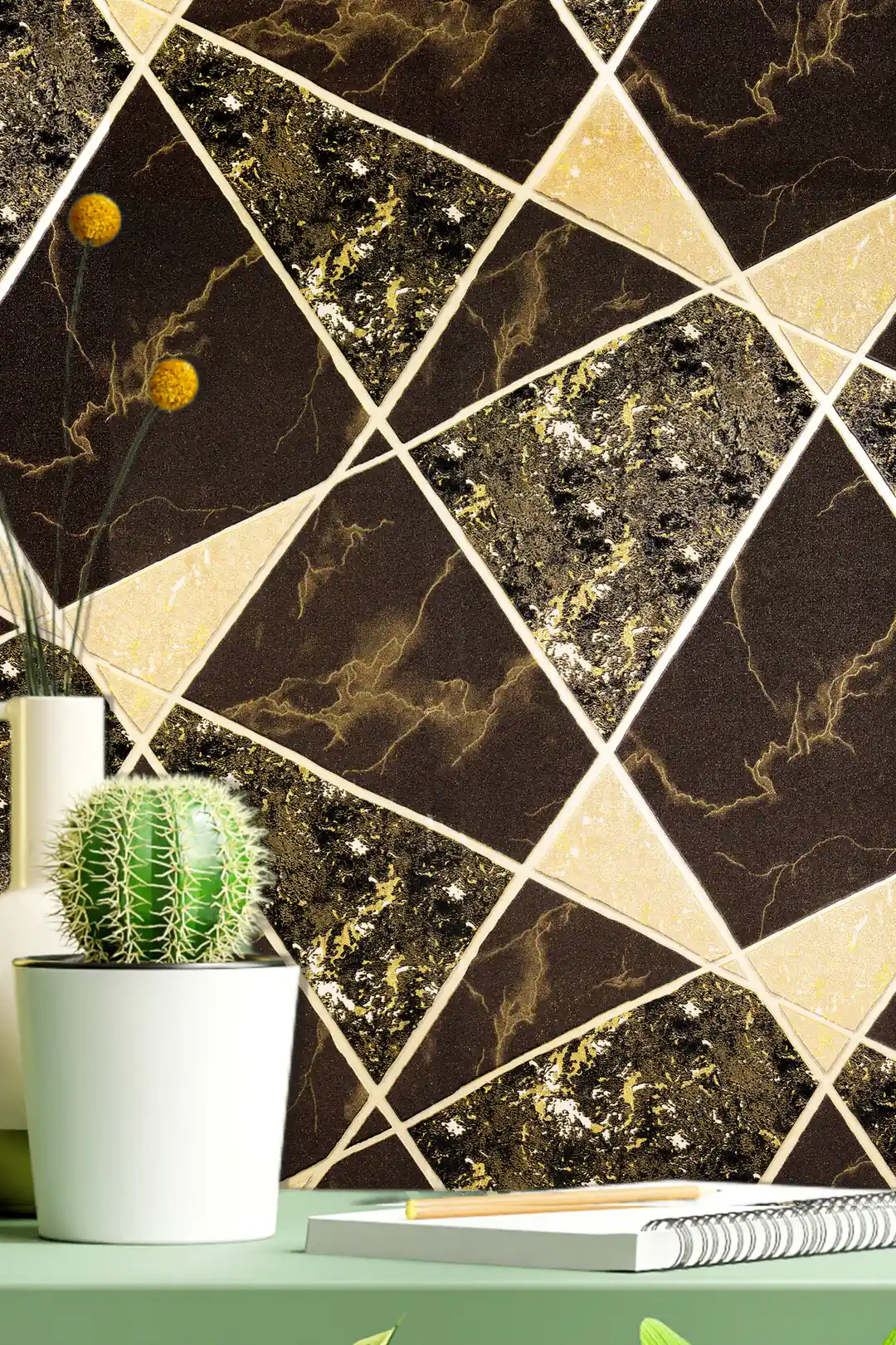Desk vignette with cactus plant and notebook against black and gold marble triangle wallpaper