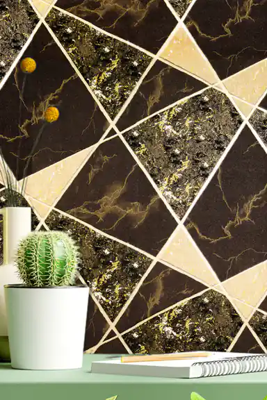 Desk vignette with cactus plant and notebook against black and gold marble triangle wallpaper