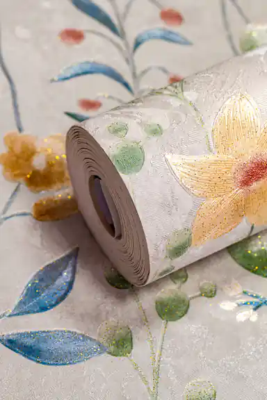 Wallpaper roll with soft botanical meadow flowers in pink, orange, and blue on a light grey background
