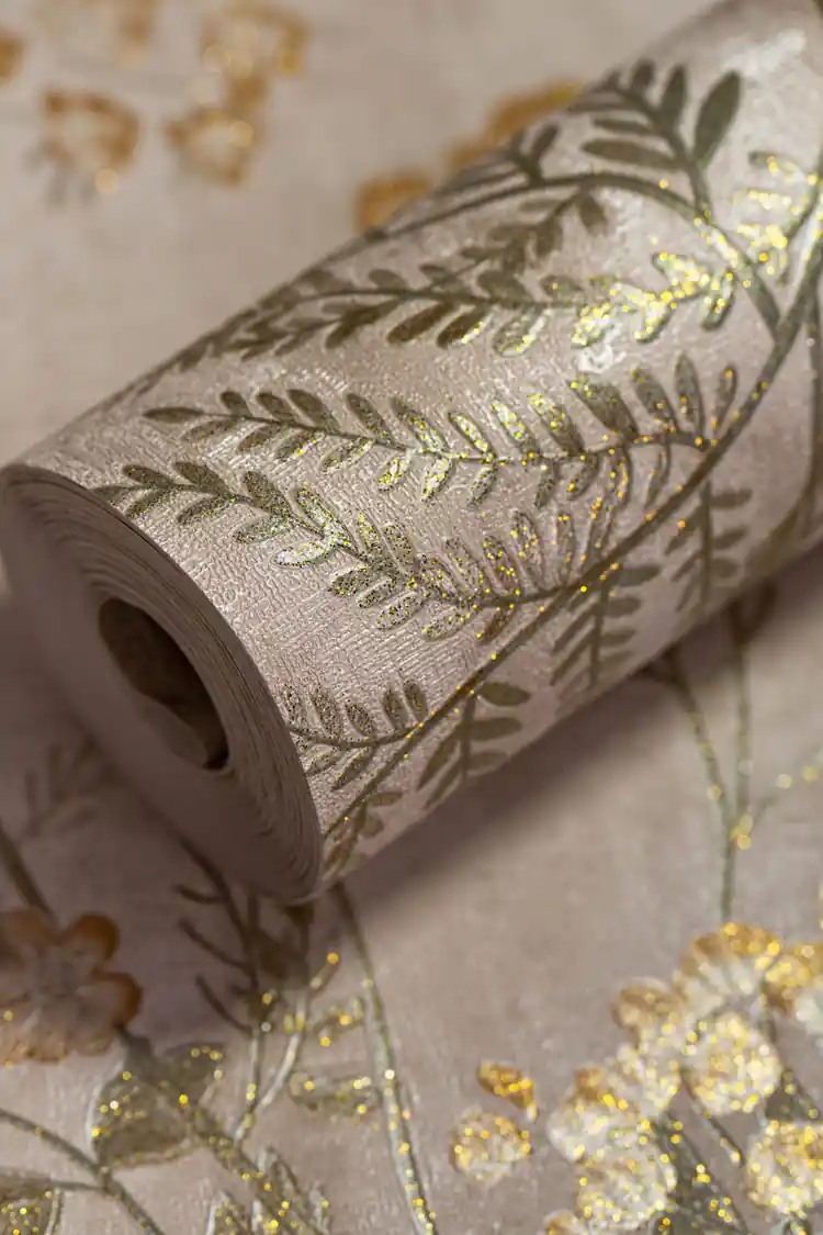 Wallpaper roll with vintage botanical fern and flower pattern in green and gold on a beige background