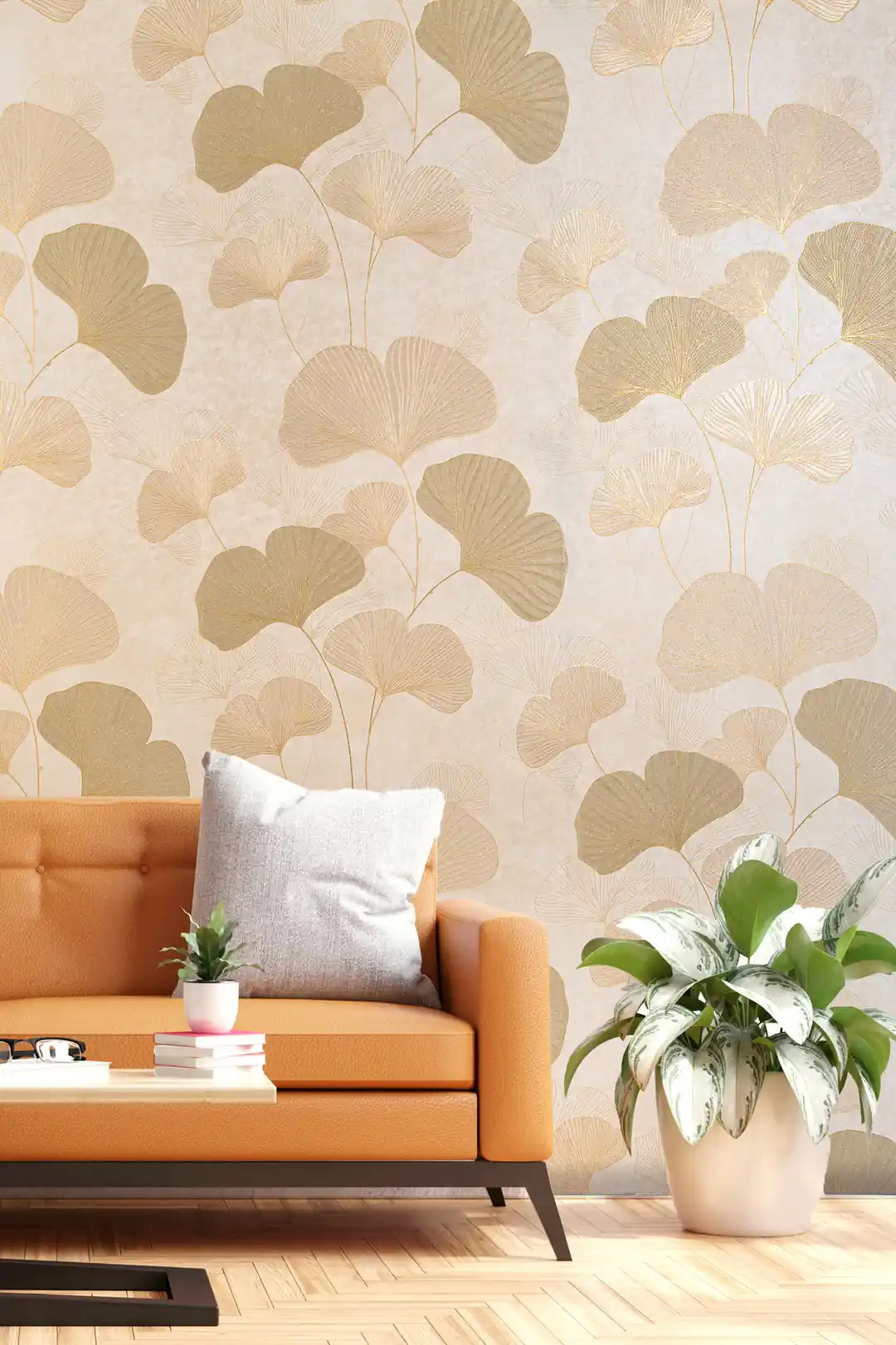 Beige ginkgo leaf wallpaper installed in a modern living room with an orange leather sofa and indoor plants