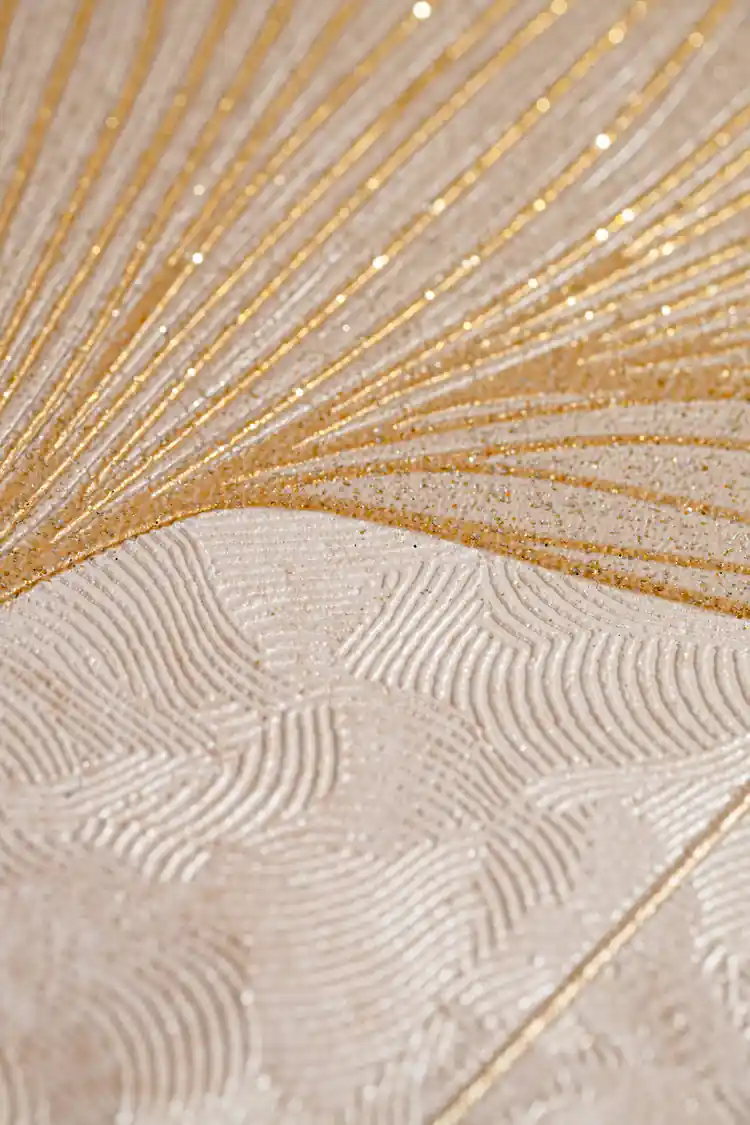Extreme close-up of beige wallpaper texture showing gold glitter veins radiating through a ginkgo leaf