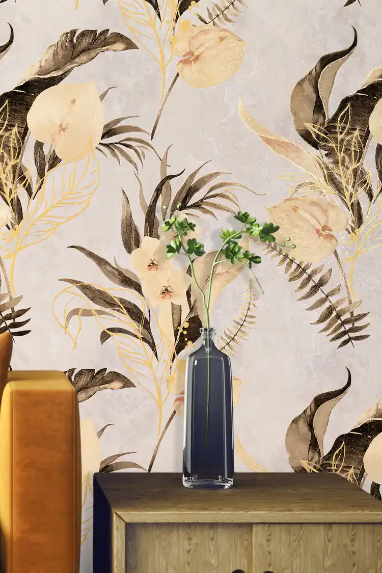 Close-up of orchid and tropical foliage wallpaper with a glass vase and amber velvet furniture accent