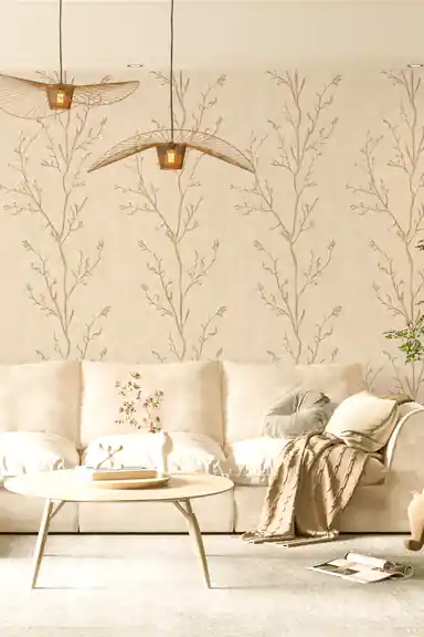 Delicate tree branches wallpaper in a serene living room with a beige sofa and woven pendant lights
