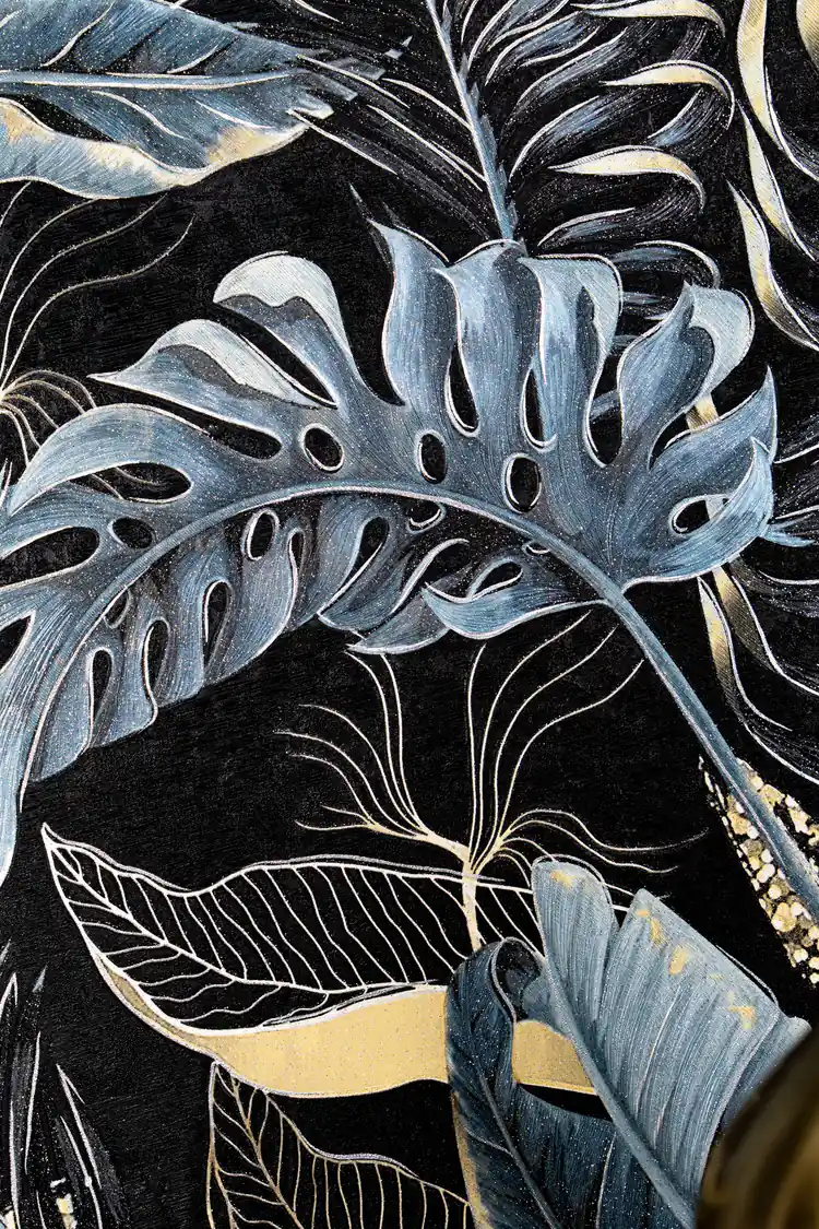 Detailed view of blue-toned monstera leaves with gold vein outlines on deep black tropical wallpaper