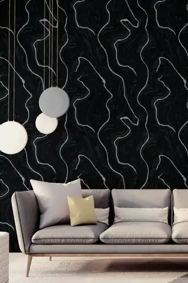 Black glitter wallpaper with silver swirl lines in a modern living room with pendant lights and grey sofa