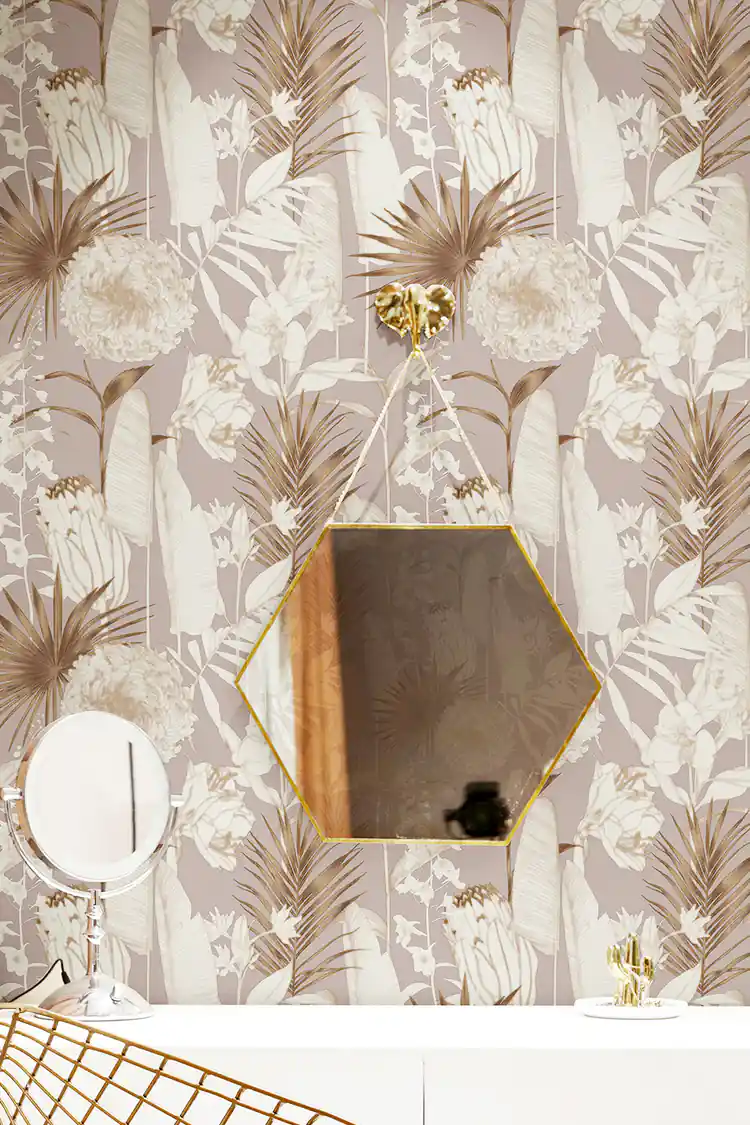 Rose gold floral wallpaper in a vanity area with a hexagonal gold mirror and botanical palm frond pattern