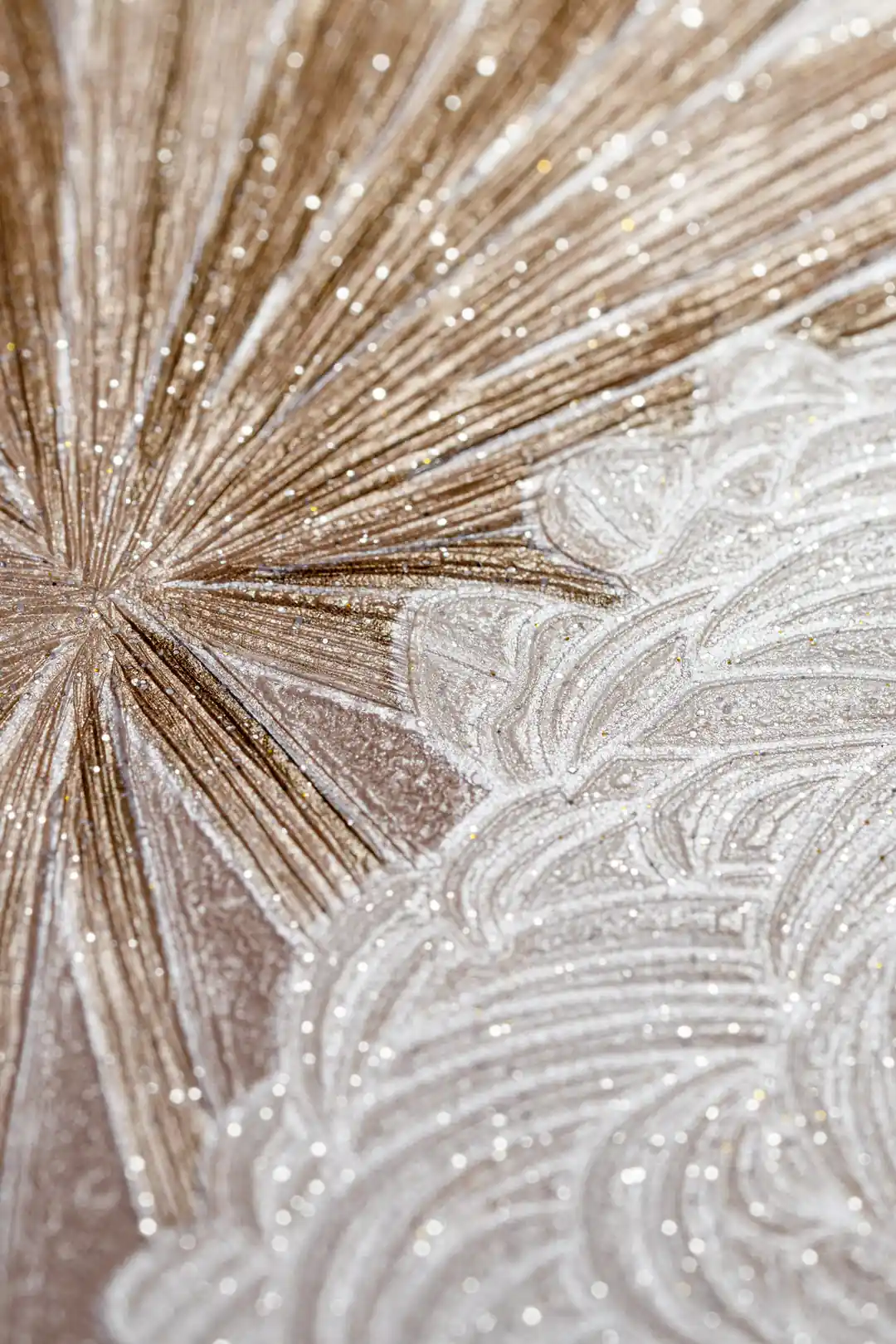 Extreme close-up of rose gold starburst and swirl pattern showing sparkling glitter texture detail