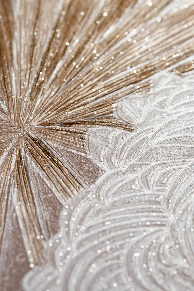 Extreme close-up of rose gold starburst and swirl pattern showing sparkling glitter texture detail