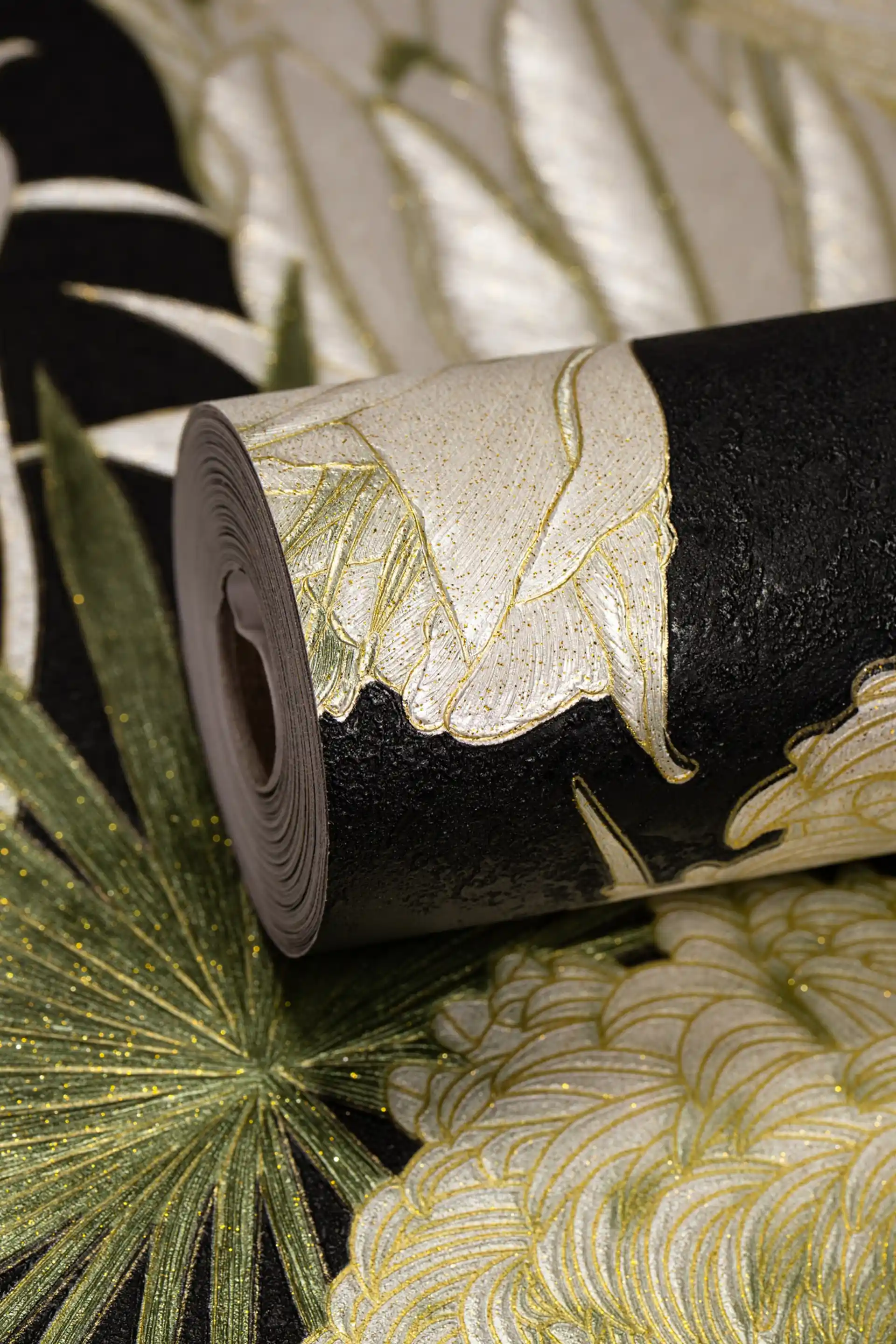 Rolled black tropical wallpaper with green palm fronds and botanical leaves featuring gold glitter accents