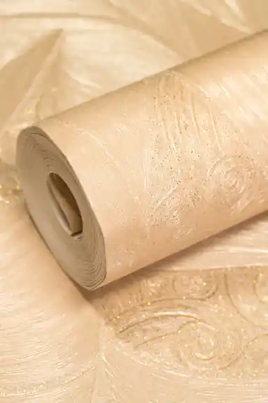 Rolled embossed beige-gold wallpaper with elegant leaf and swirl pattern featuring glitter accents