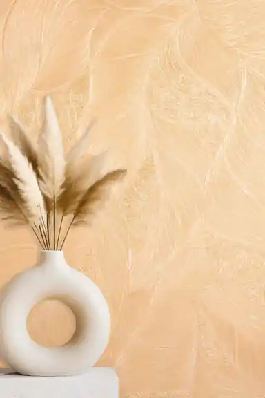 Close-up of embossed leaf and swirl wallpaper with a pampas grass arrangement in a ring-shaped vase