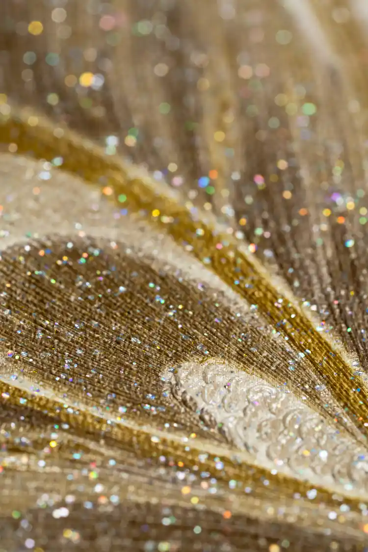 Extreme close-up showing iridescent glitter texture on the peacock feather wallpaper surface