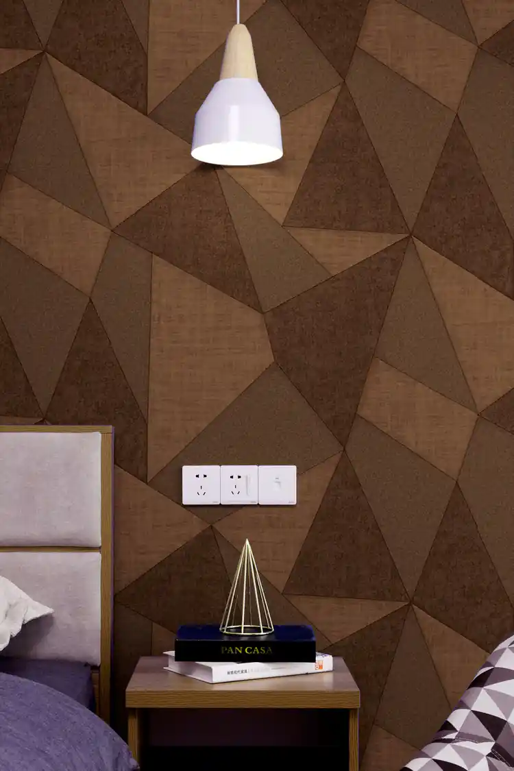 Brown 3D triangle wallpaper installed in a modern bedroom with pendant light and bedside table