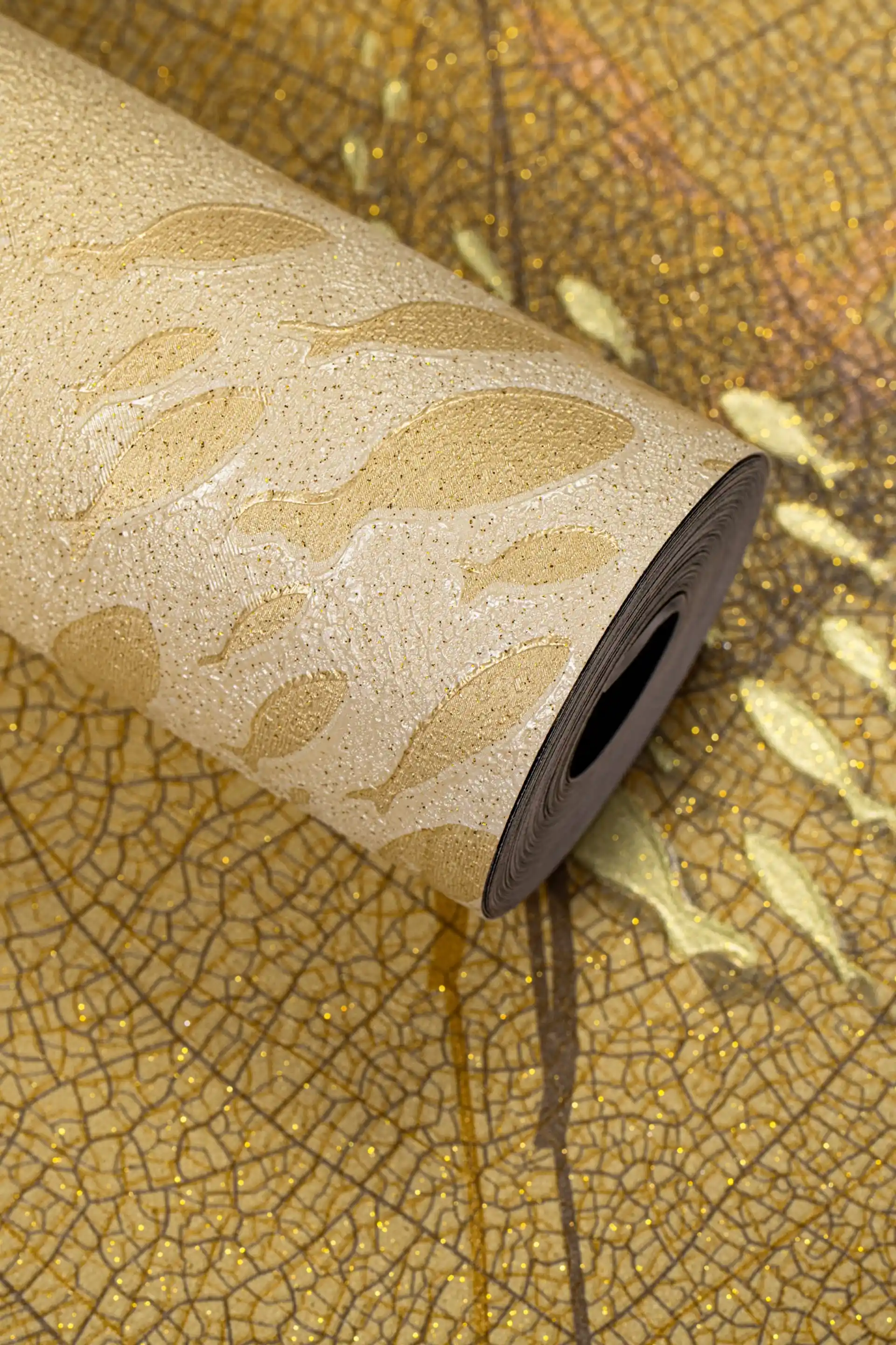 Full roll of gold veined leaf wallpaper with crackle texture on a warm gold background
