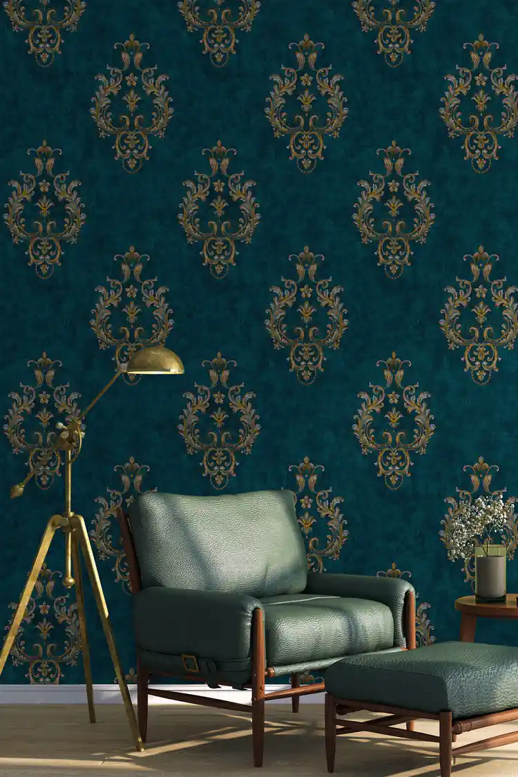 Teal damask wallpaper installed in a living room with green leather armchair and gold tripod lamp