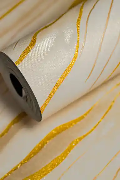 Full roll of cream marble wallpaper with flowing gold metallic line detailing on a soft base