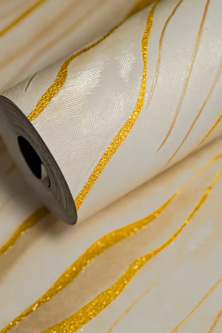 Full roll of cream marble wallpaper with flowing gold metallic line detailing on a soft base