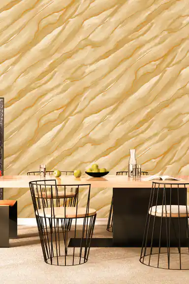Cream and gold wave-textured wallpaper installed in a dining room with geometric wire-frame chairs and wooden table
