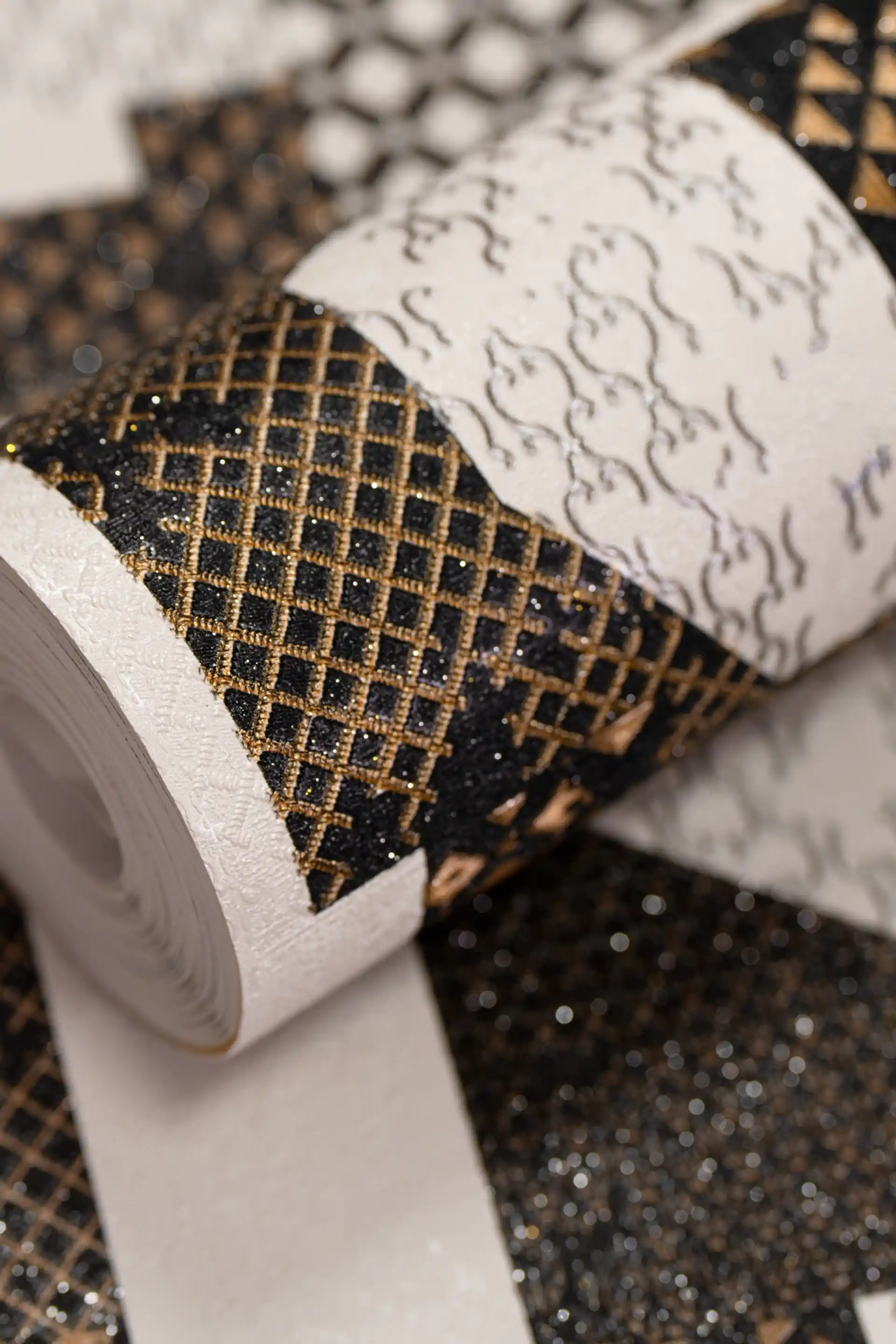 Full roll of bold geometric mix wallpaper with black, white, and gold abstract sparkle pattern
