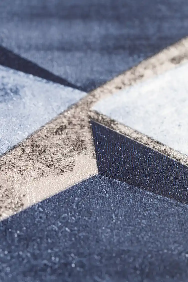 Extreme close-up of 3D blue cube wallpaper showing geometric depth and matte texture detail