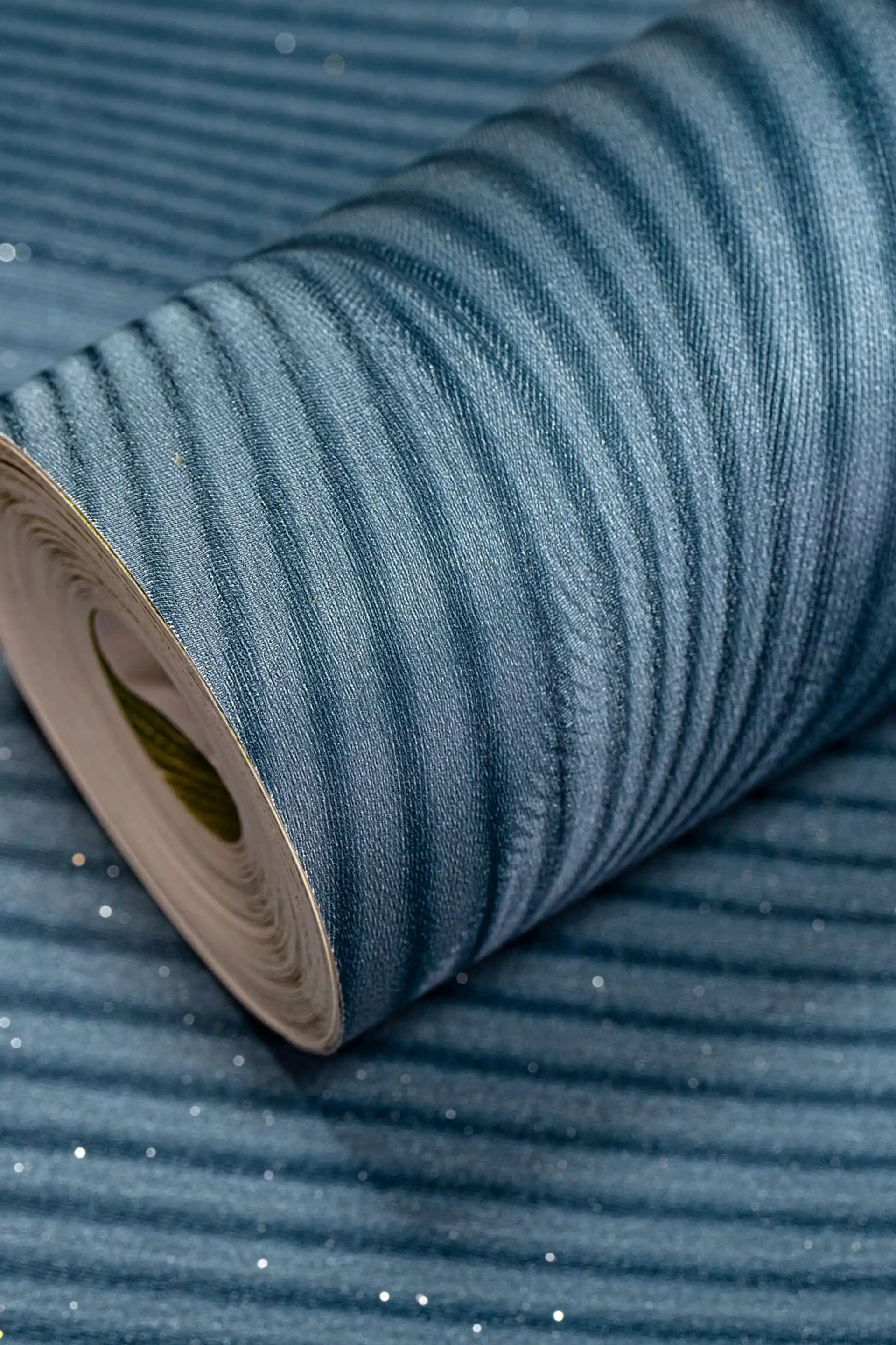 Full roll of teal wave illusion wallpaper with 3D optical ripple design and shimmer sparkle