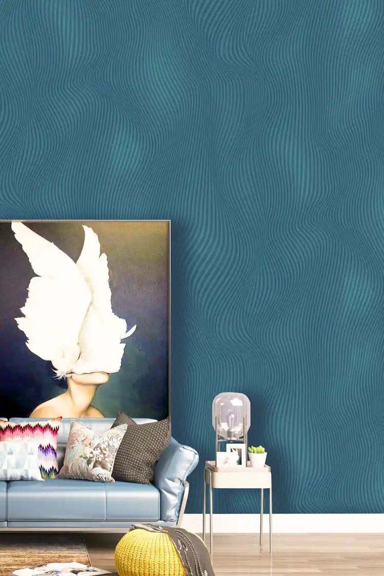 Teal wave illusion wallpaper installed in a living room with blue sofa, art painting, and decor