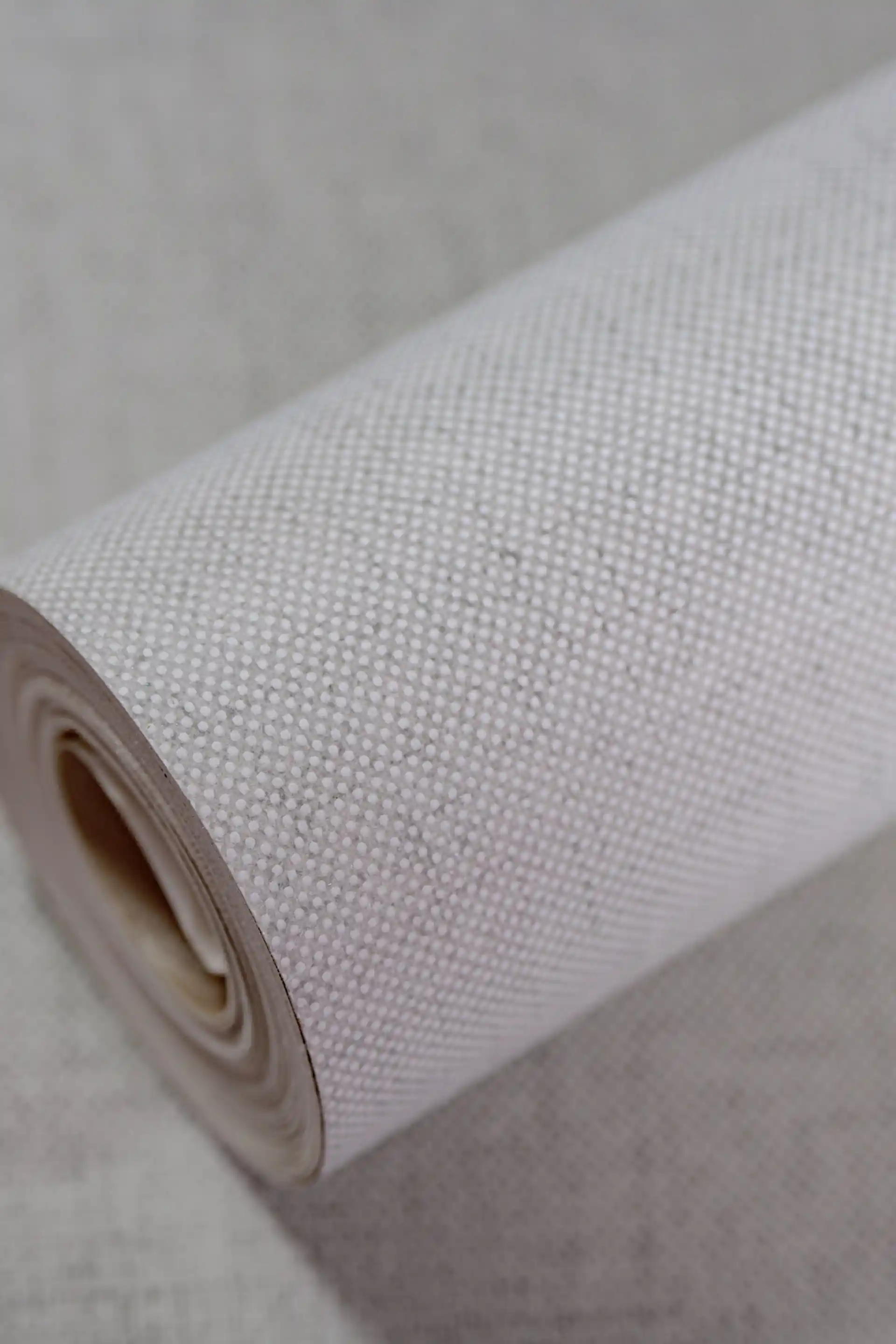 Full roll of grey grasscloth wallpaper with soft woven shimmer finish in neutral tone