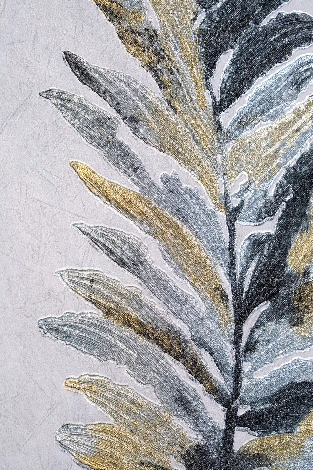 Detailed view of grey and gold fern leaf pattern showing painted brushstroke texture on wallpaper