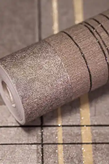 Full roll of modern block stripe wallpaper with black and gold lines on a grey taupe base