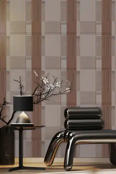 Brown and grey geometric block pattern wallpaper installed in a room with modern black chrome chair and cherry blossom branch