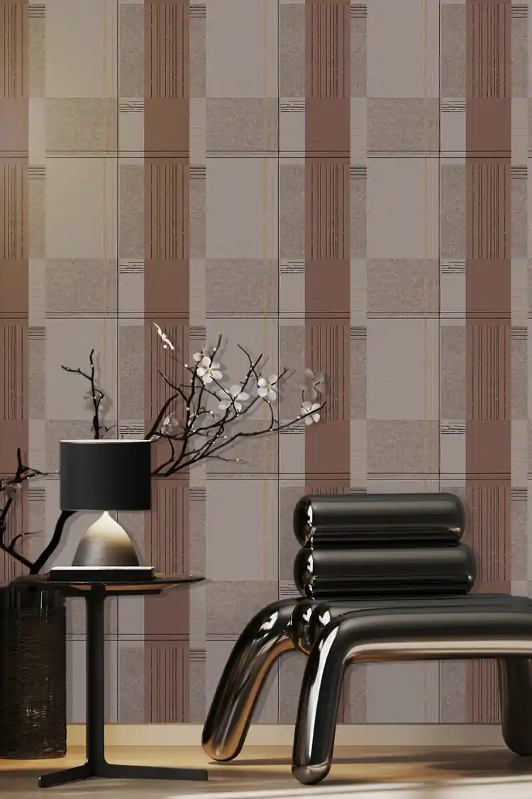 Brown and grey geometric block pattern wallpaper installed in a room with modern black chrome chair and cherry blossom branch