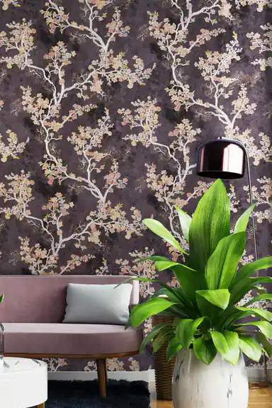 Cherry blossom wallpaper in a living room with mauve sofa, tropical plant, and pendant lamp