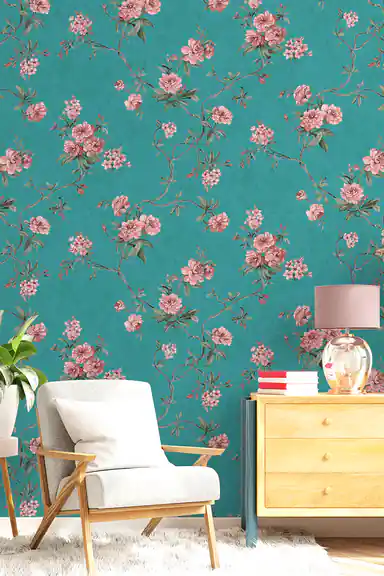 Living room scene with pink floral vine wallpaper on teal blue base behind armchair and dresser