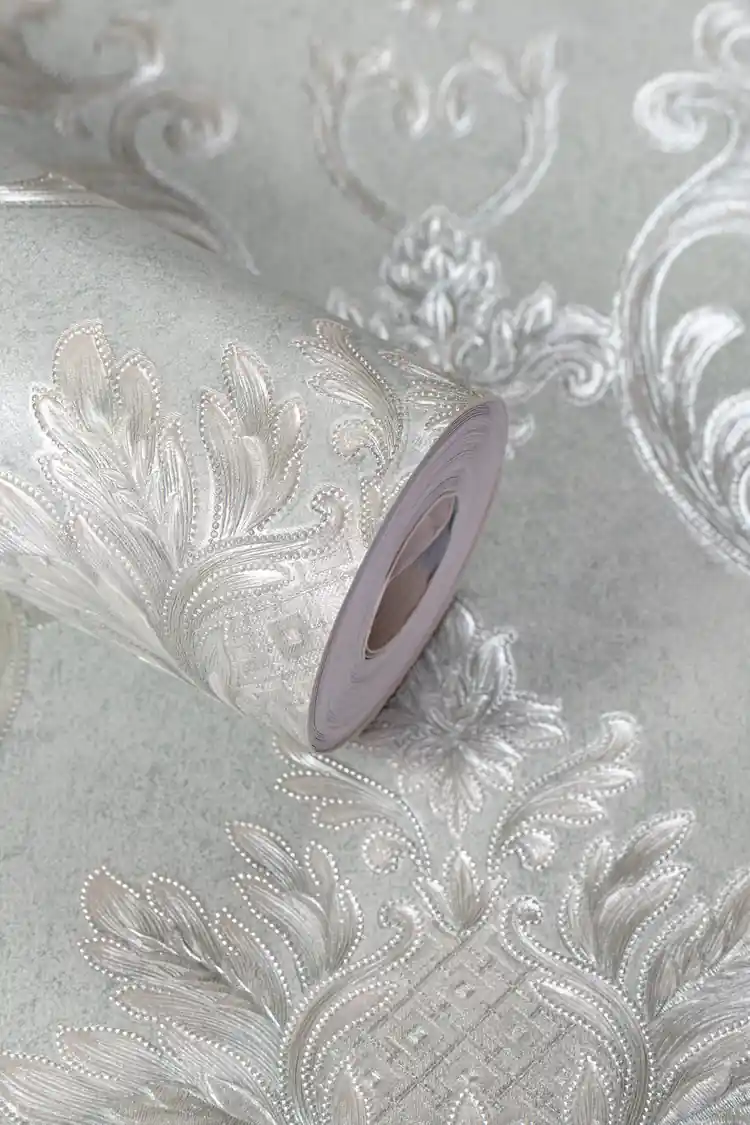 Mint green damask wallpaper roll with embossed shimmer scrollwork and floral medallions