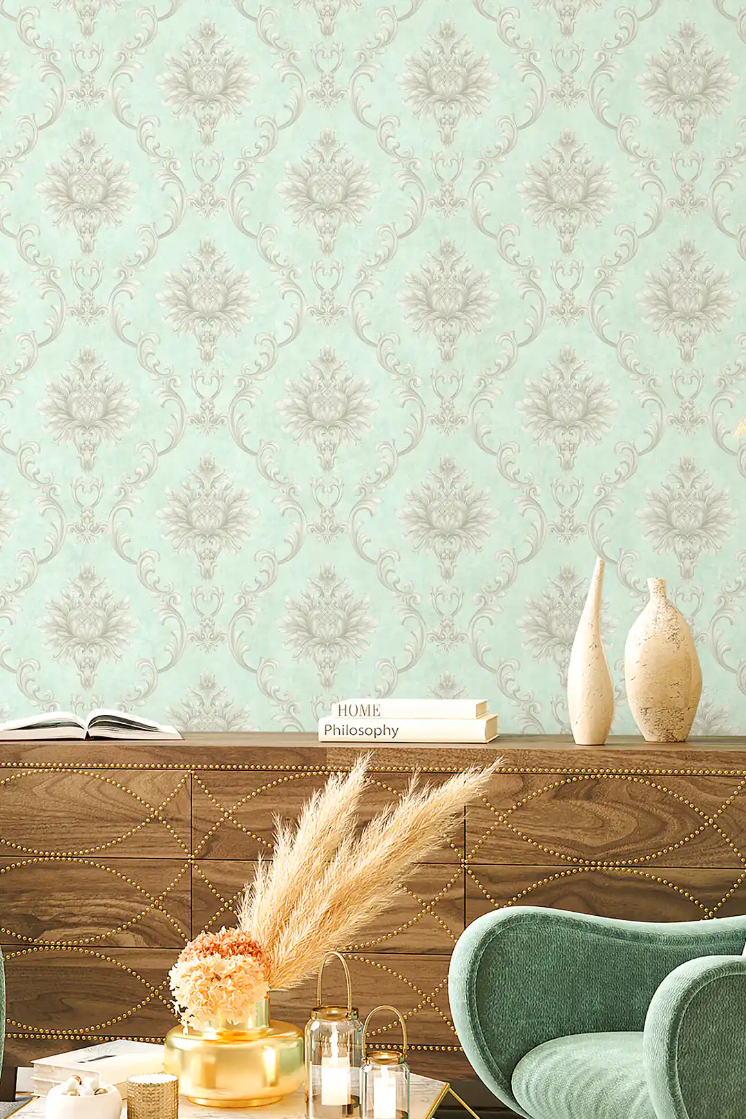 Elegant living room featuring mint damask wallpaper behind wooden credenza, teal chair, and vases