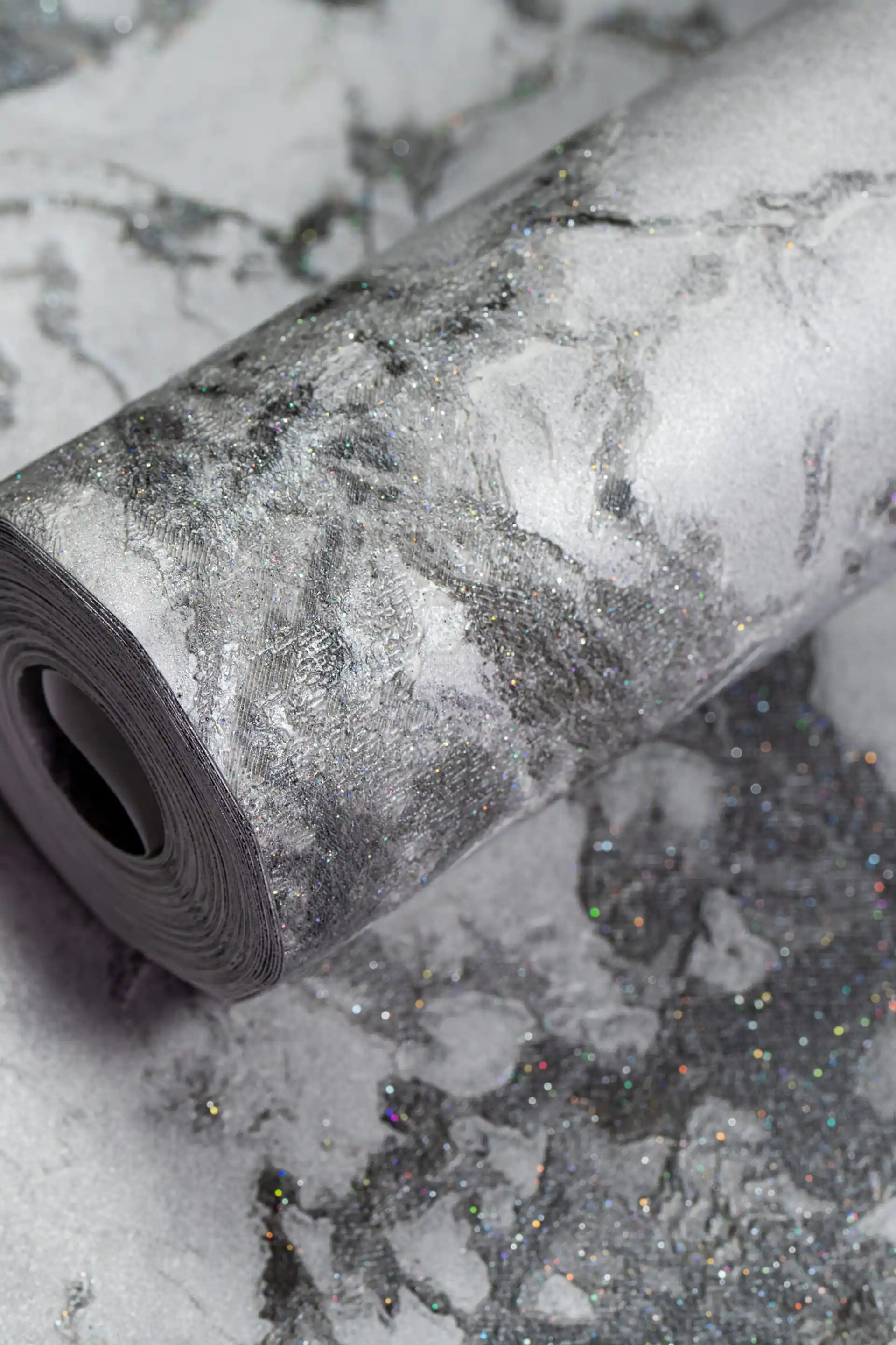Grey marble effect wallpaper roll with holographic glitter specks on dark and light grey veining