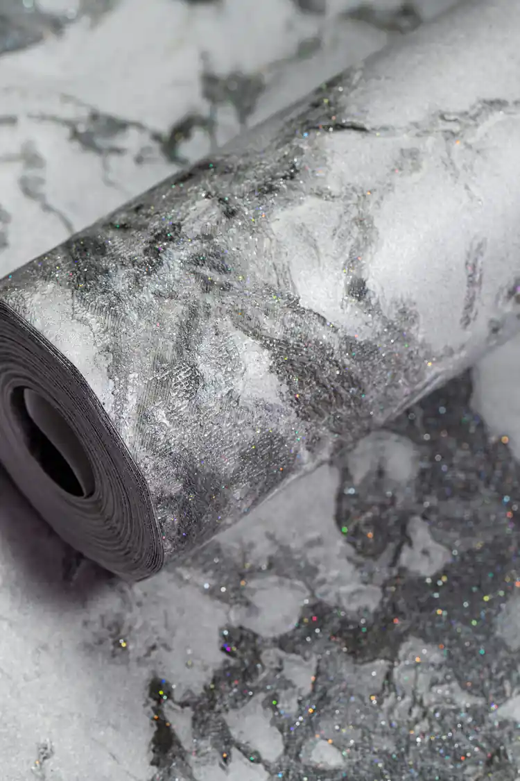 Grey marble effect wallpaper roll with holographic glitter specks on dark and light grey veining