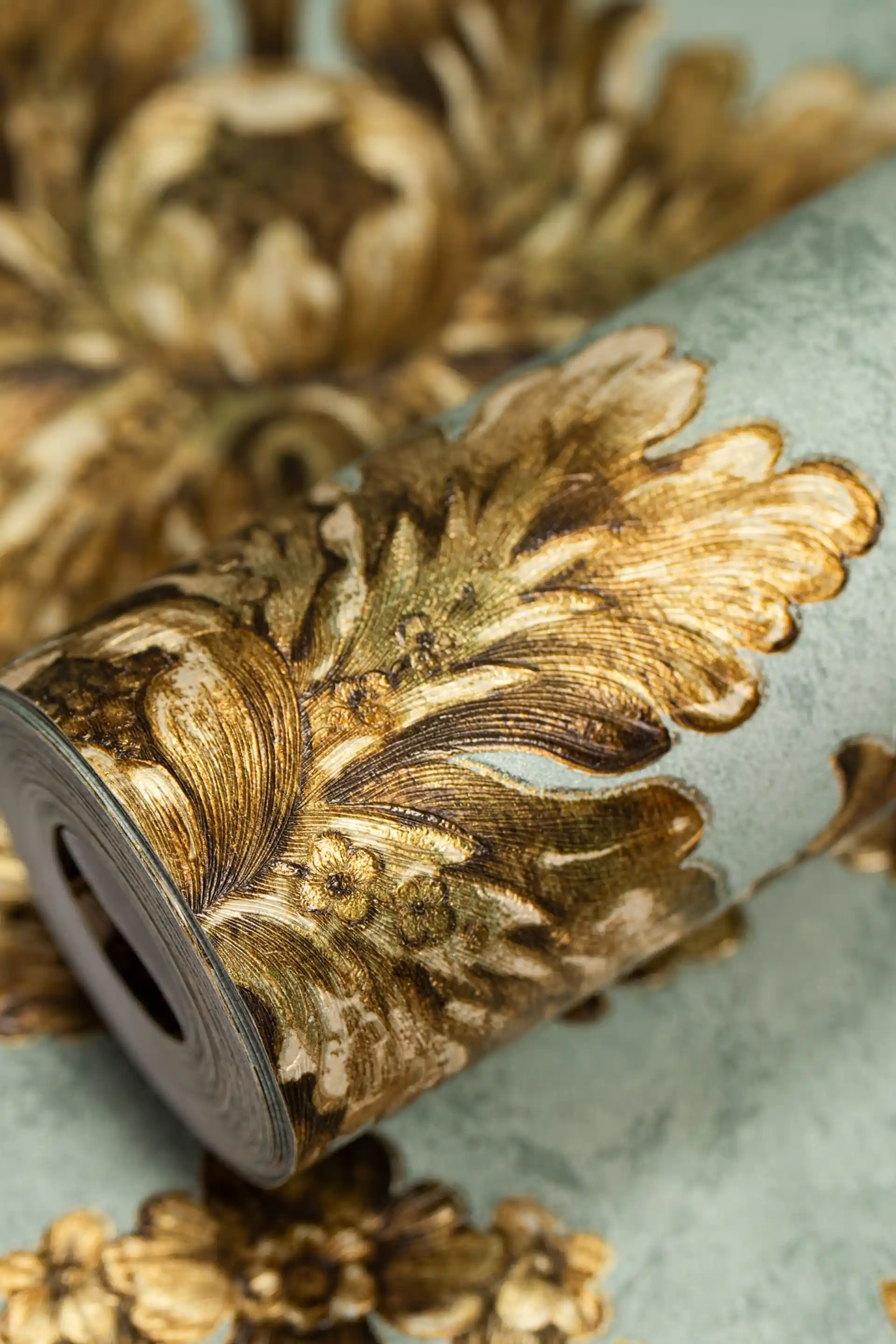 Sage green baroque wallpaper roll with large embossed gold acanthus leaf medallion pattern