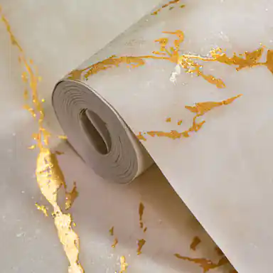 Beige marble effect wallpaper roll with golden shimmer veining on a warm cream base