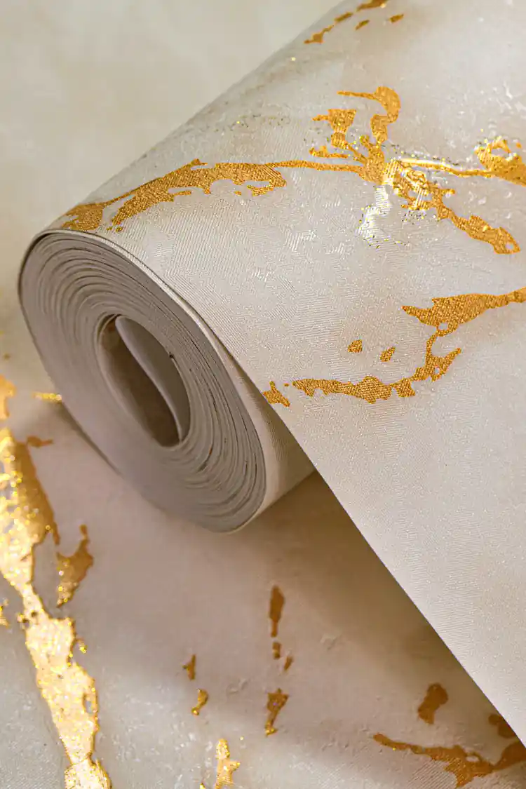 Beige marble effect wallpaper roll with golden shimmer veining on a warm cream base