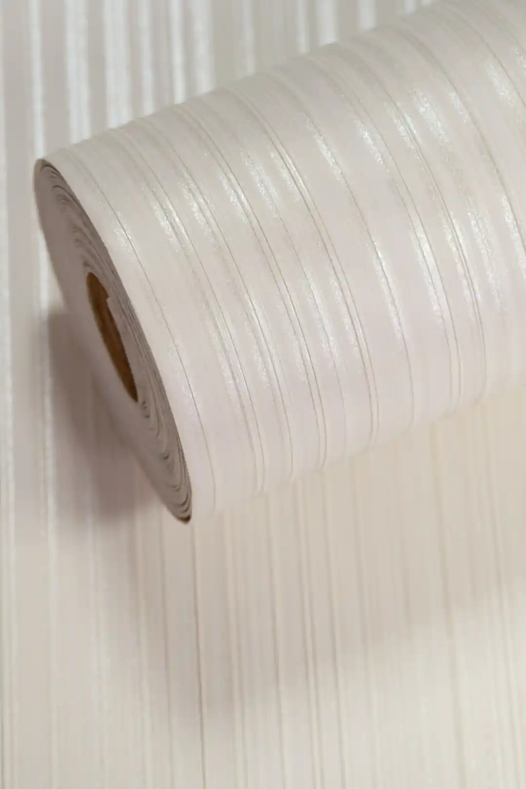 White silk stripe wallpaper roll with vertical shimmer lines and subtle finish