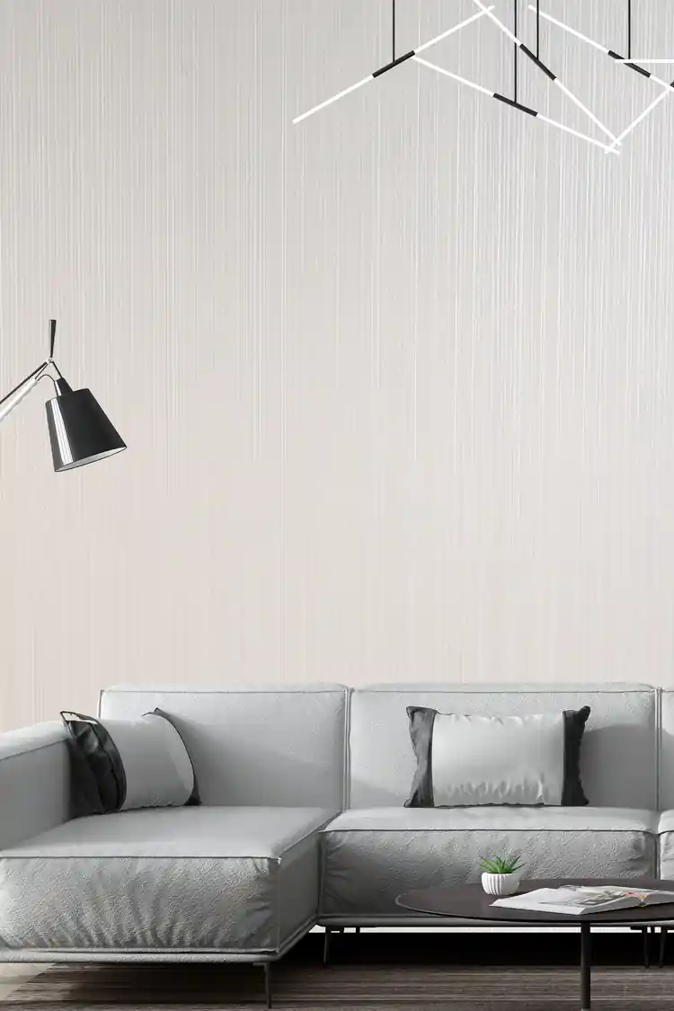 Installed wall with white vertical shimmer stripe wallpaper in a styled room scene