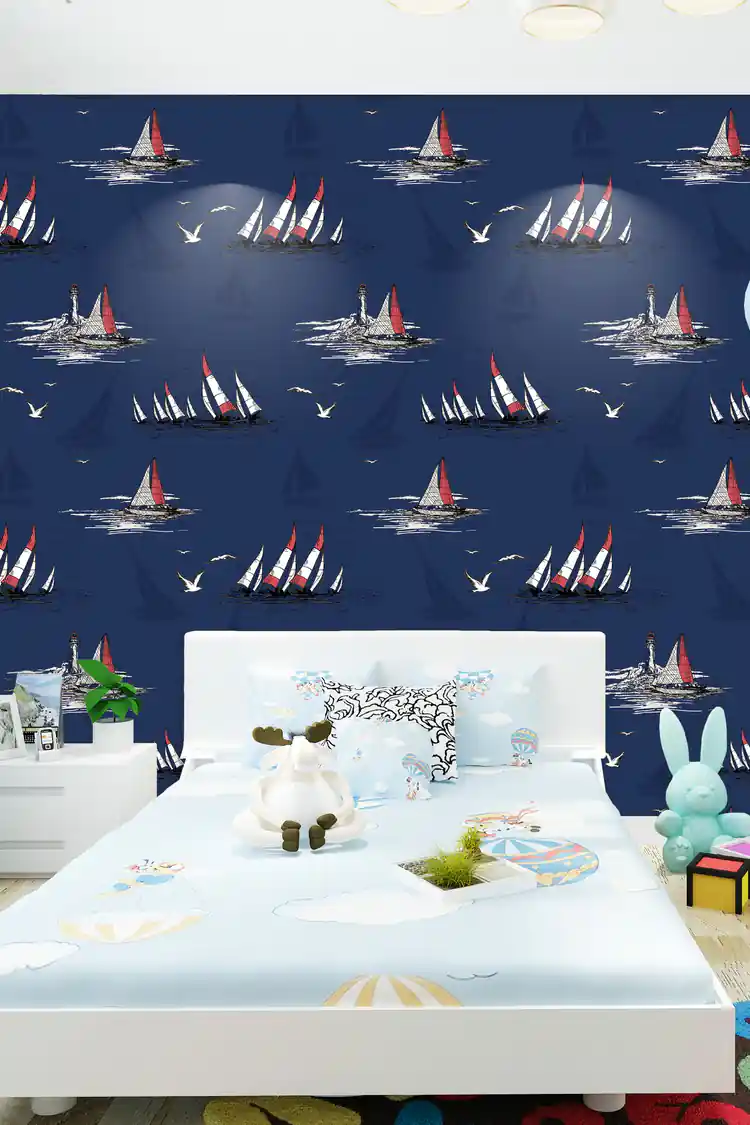 Kids bedroom with navy nautical sailboat wallpaper behind white bed with stuffed animals