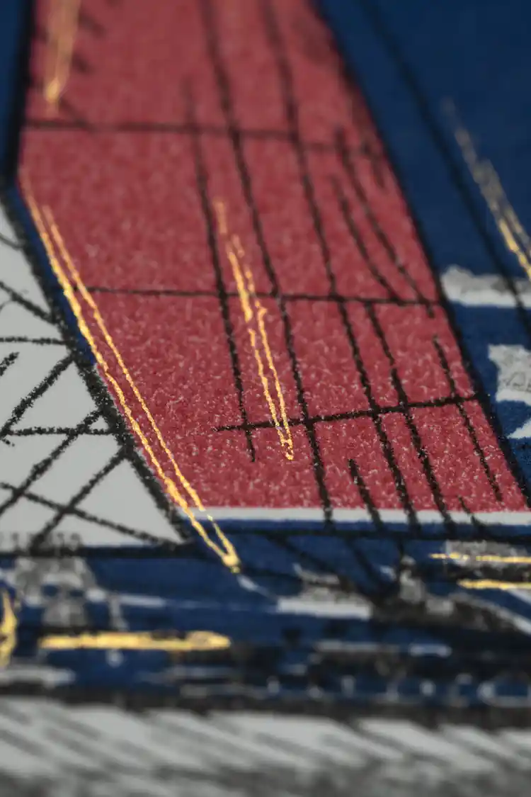 Extreme close-up of red sailboat sail texture showing embossed glitter detail on navy wallpaper