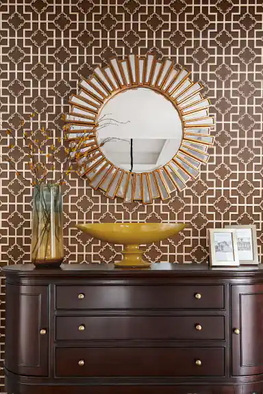Elegant brown geometric trellis wallpaper with embossed gold quatrefoil accents on dark base