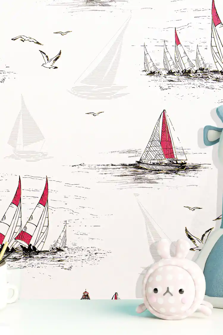 Close-up of red and white sailboats with seagulls on white wallpaper beside soft bunny toy
